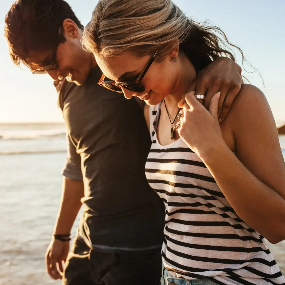 Smiling man and woman, arms linked, celebrating pain-free life after non-surgical treatment at Regenerative Pain & Spine.