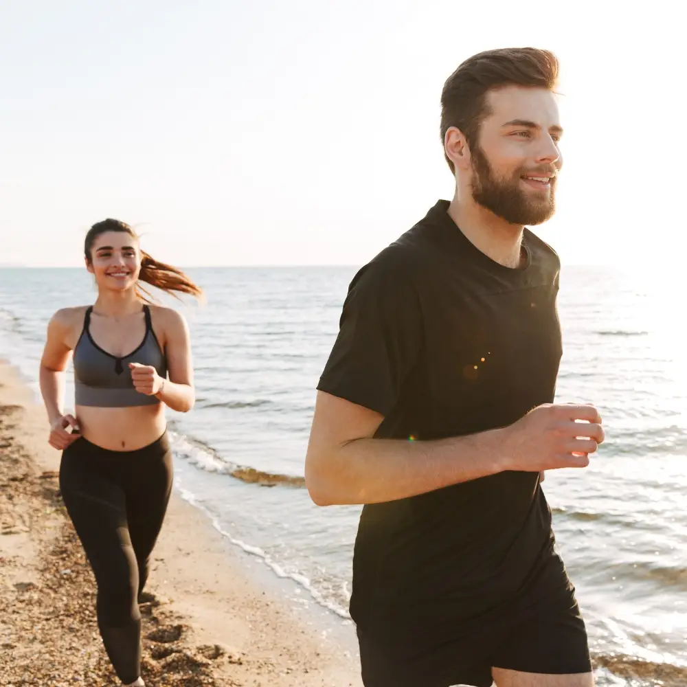 Man and woman jogging at sunrise, enjoying non-surgical pain relief in Chicago with regenerative care that supports active lifestyles.