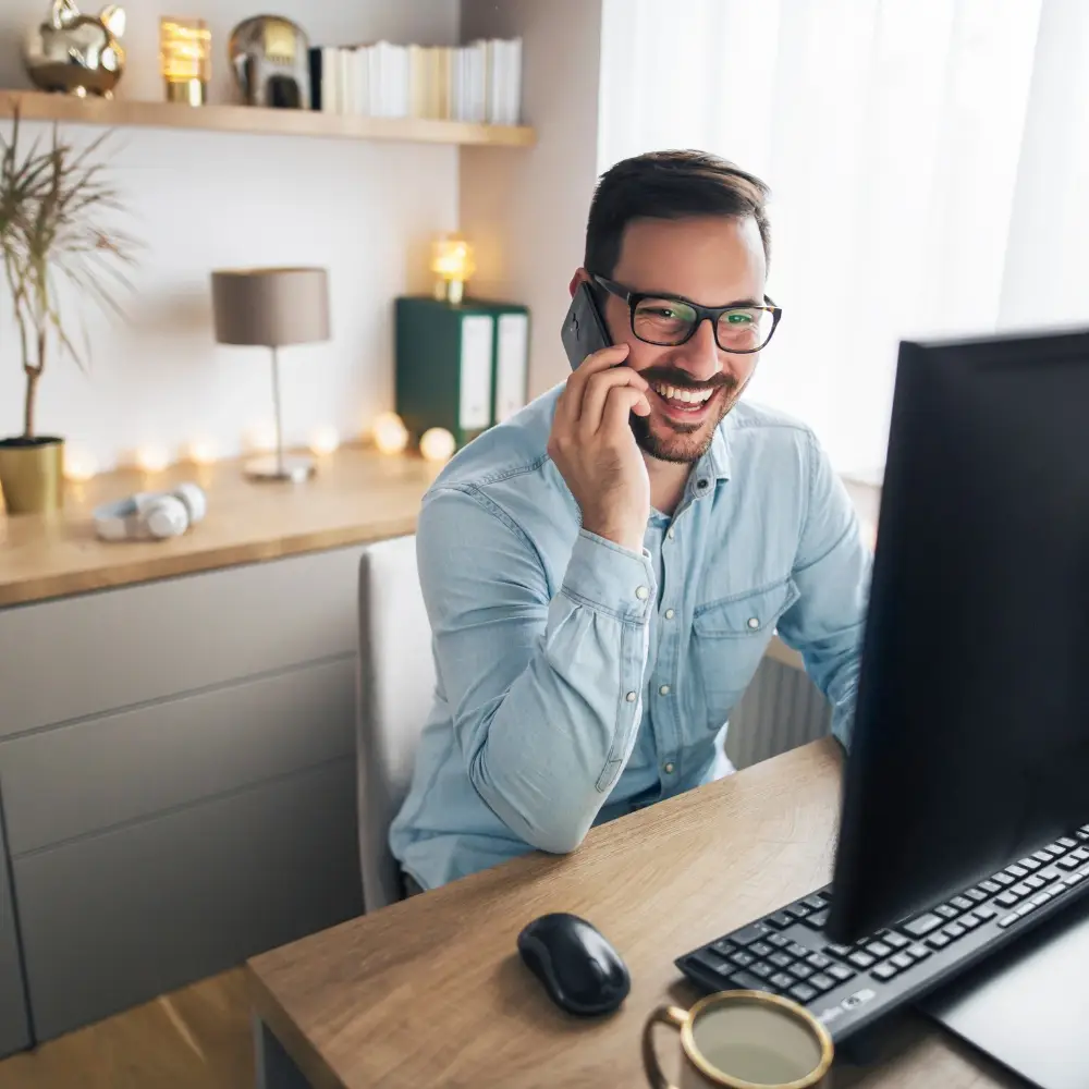 Smiling man working from home, feeling pain-free and productive thanks to non-surgical pain relief in Chicago with regenerative care.